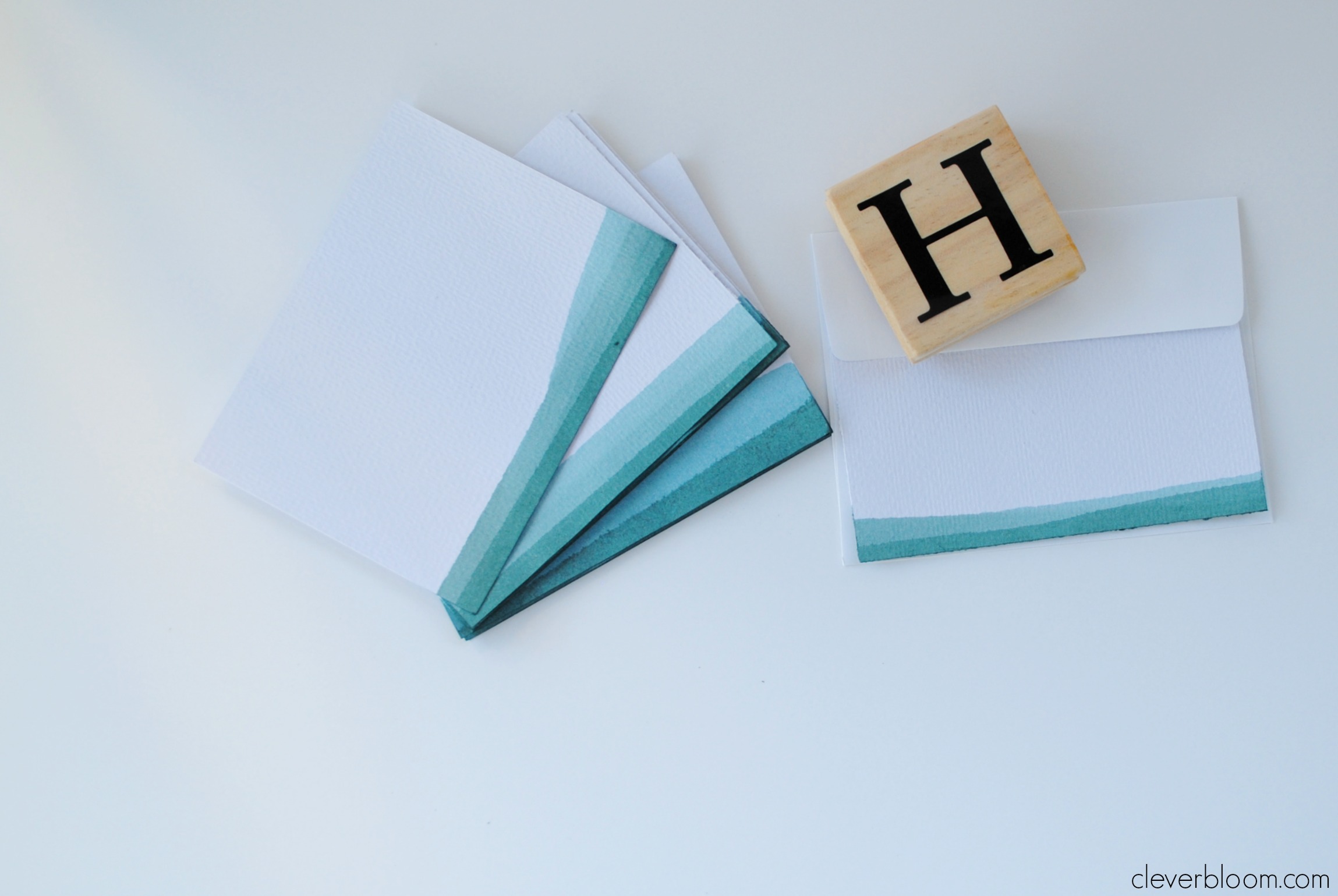 Learn how to make this beautiful dip-dyed stationary using Rit Dye and watercolor paper. This technique is perfect for stationary, cards, gift tags, business cards, and more.