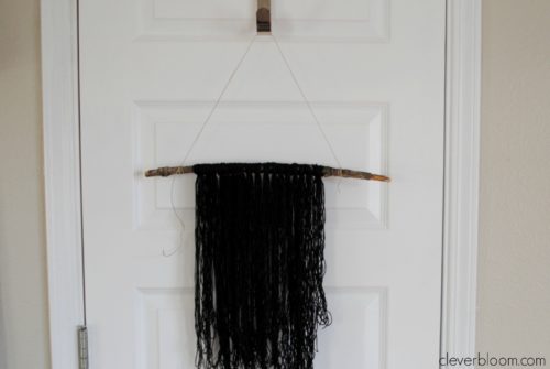 Do you have an empty space on your wall that needs to be filled? This DIY Yarn Wall Hanging is perfect! It's simple, inexpensive and very customizable. You won't believe how easy it is and it takes no time at all!