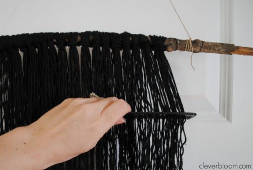 Do you have an empty space on your wall that needs to be filled? This DIY Yarn Wall Hanging is perfect! It's simple, inexpensive and very customizable. You won't believe how easy it is and it takes no time at all!